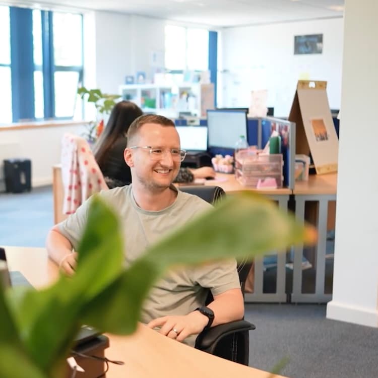 Joe Husbands L&D Consultant smiling at someone in the office